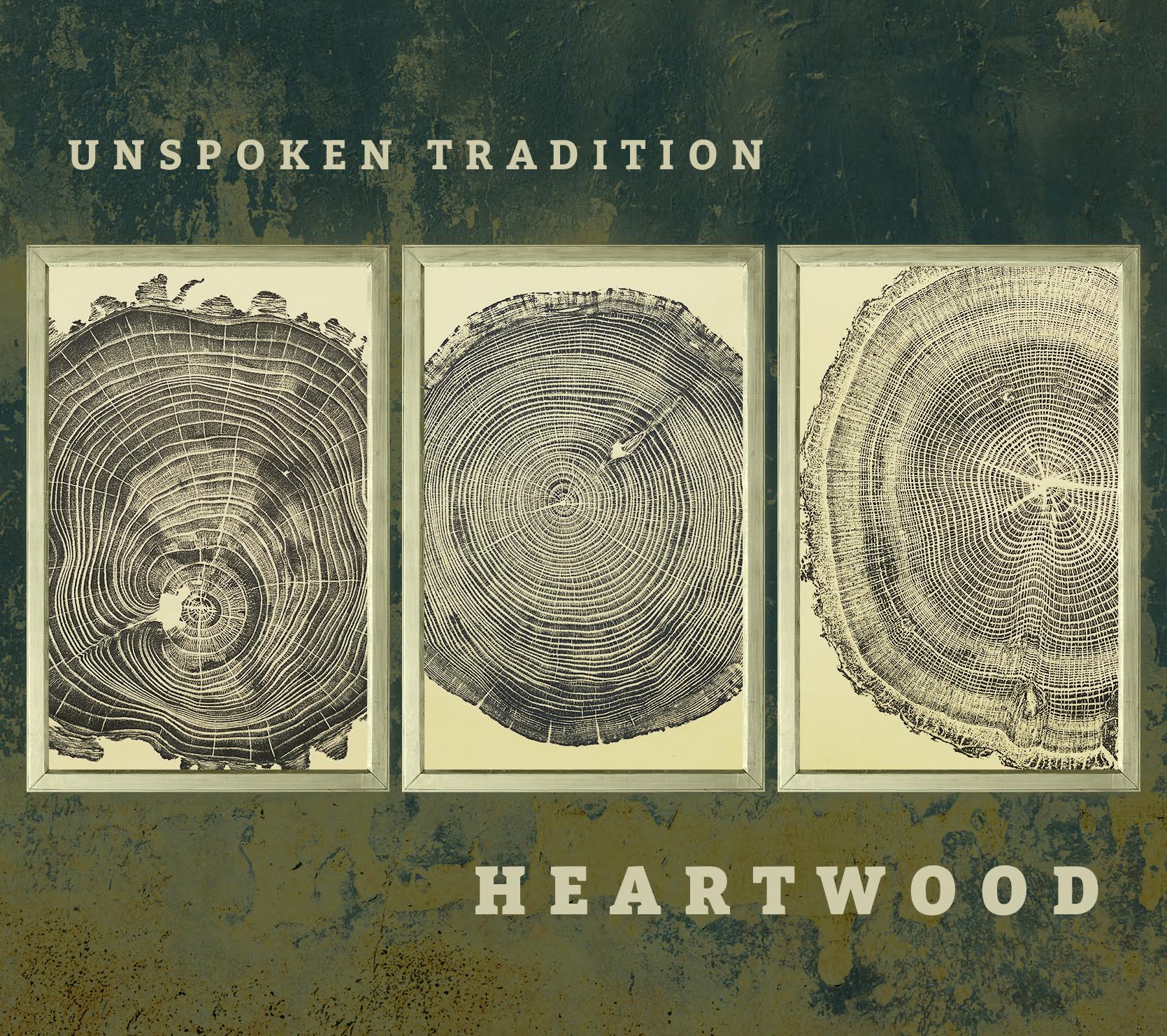 Triptych of framed tree-ring prints on a weathered green wall, with the title UNSPOKEN TRADITION above and HEARTWOOD below.