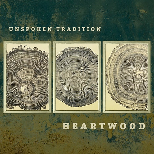Album art for Unspoken Tradition: Heartwood, featuring three framed tree-ring panels on a textured green-brown backdrop.
